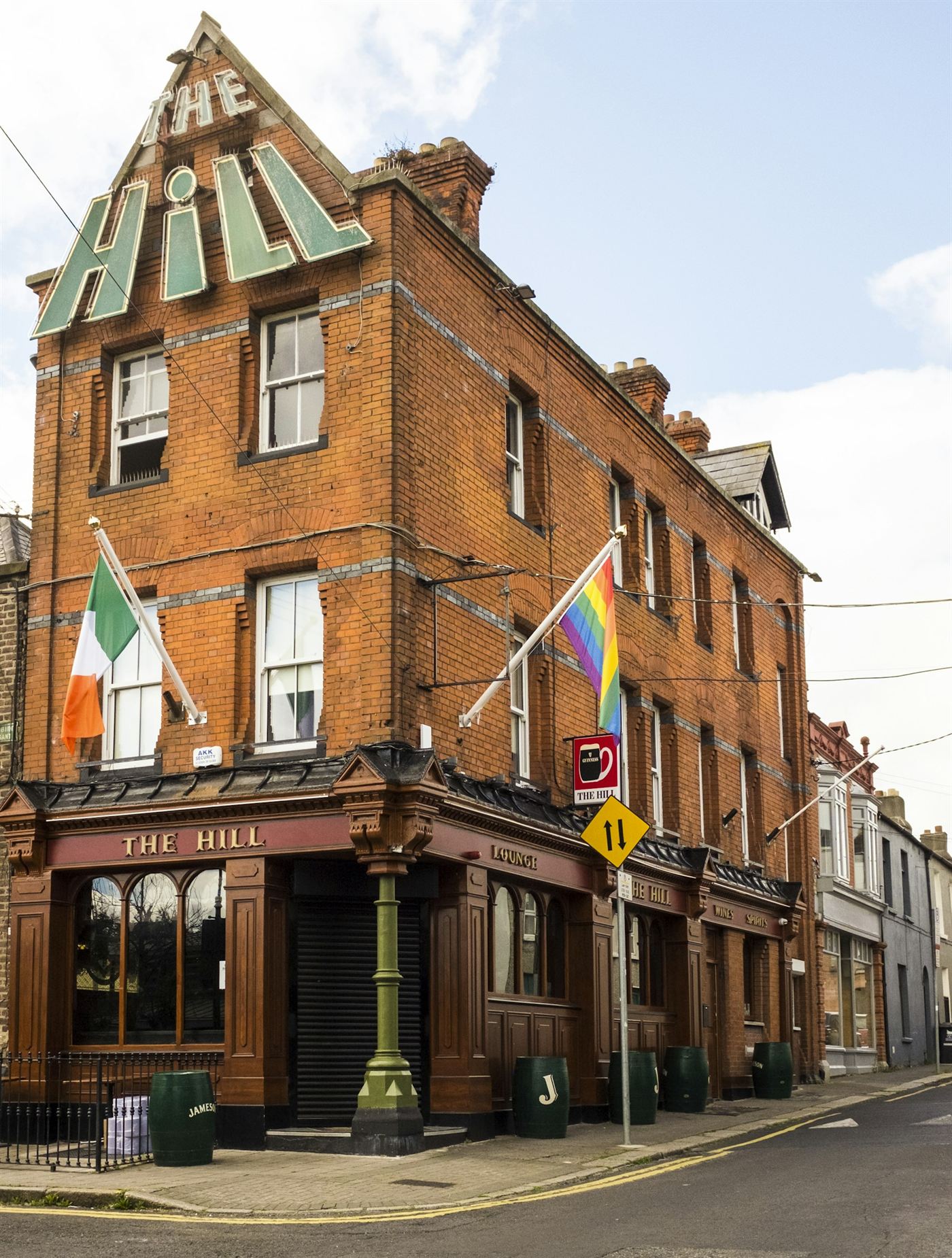 A neighborhood bar on a brick street corner